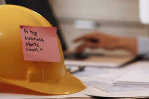 A big business starts small sticky note on construction hat