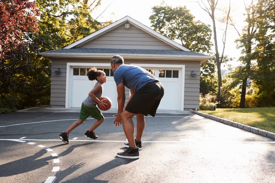 People playing basketball in front of garage door